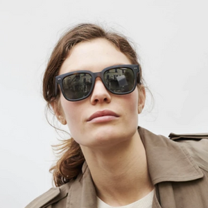 Woman wearing large dark sunglasses