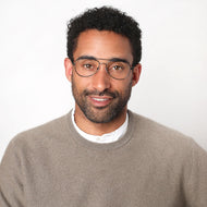 
Gunmetal aviator glasses with clear lenses are worn by a person.