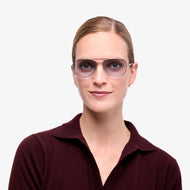 
A person wears shiny silver aviator frames with blue tinted lenses.