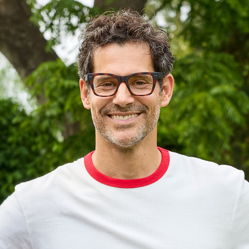 
A person wears square tortoise frames with clear lenses.