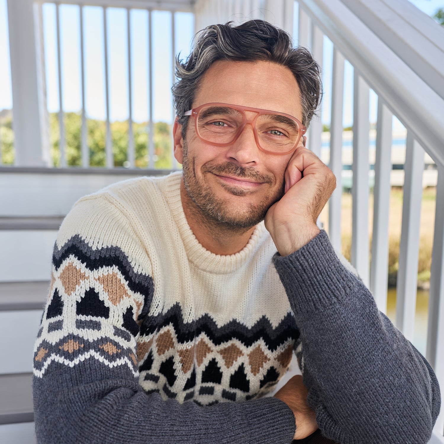 
A man wears translucent champagne rounded rectangular frames with clear lenses.