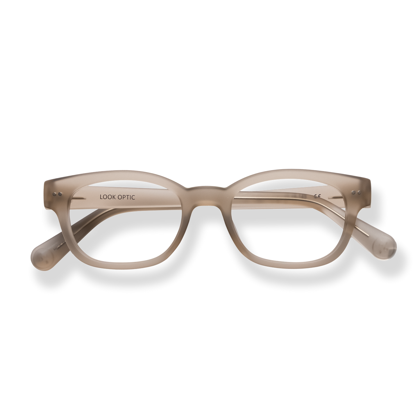 
Translucent beige rectangular eyeglasses with tortoiseshell arms and silver rivet details.