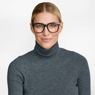 
A person is wearing shiny pink tortoise square frames with lightly tinted lenses.