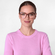 
A person is wearing square frames in a shiny pink finish with clear lenses.
