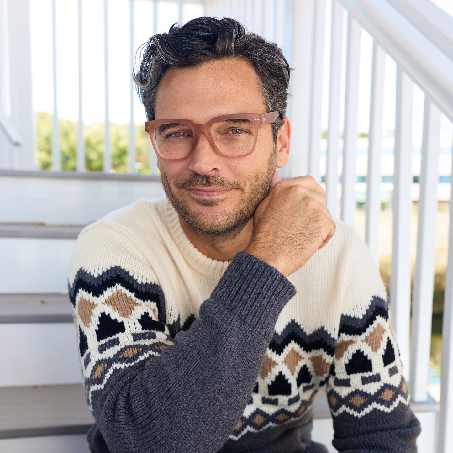 
A man wears translucent champagne square frames with clear lenses.