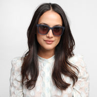 LA40XNAV10, LA40XNAV15, LA40XNAV20, LA40XNAV25 - A person is wearing square navy frames with a glossy finish and dark brown tinted lenses.