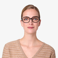 LS95PSBL10, LS95PSBL15, LS95PSBL20, LS95PSBL25, LS95PSBL30 - A person is wearing shiny black oval frames with clear lenses.