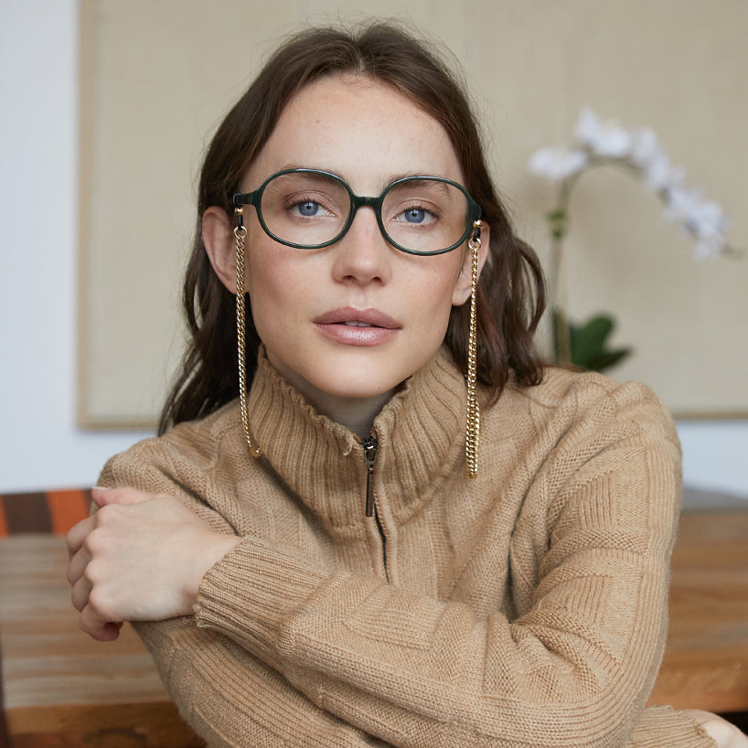 LS95PSJD10, LS95PSJD15, LS95PSJD20, LS95PSJD25, LS95PSJD30 - A person wears oval shiny jade frames with clear lenses.
