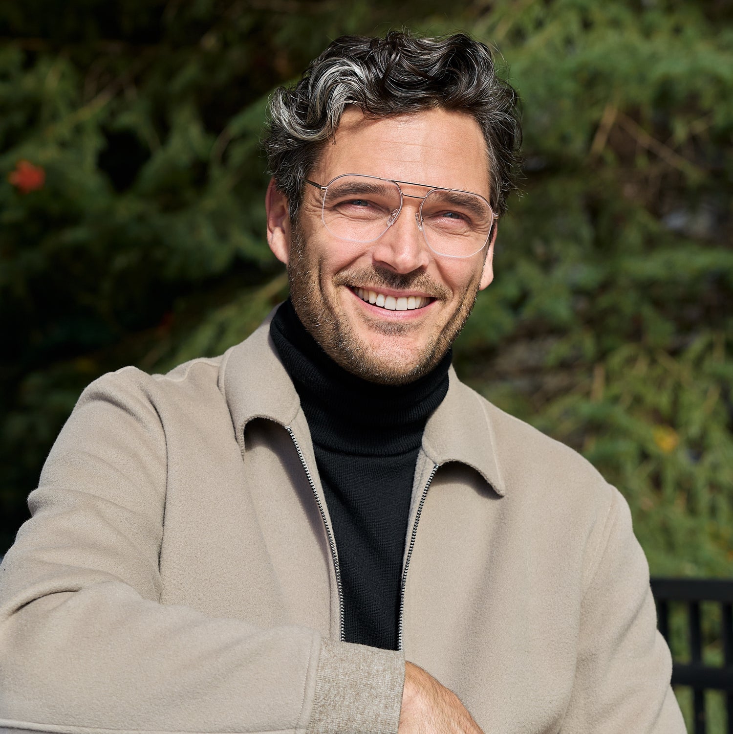 
A man wears shiny rose gold square metal frames with clear lenses.