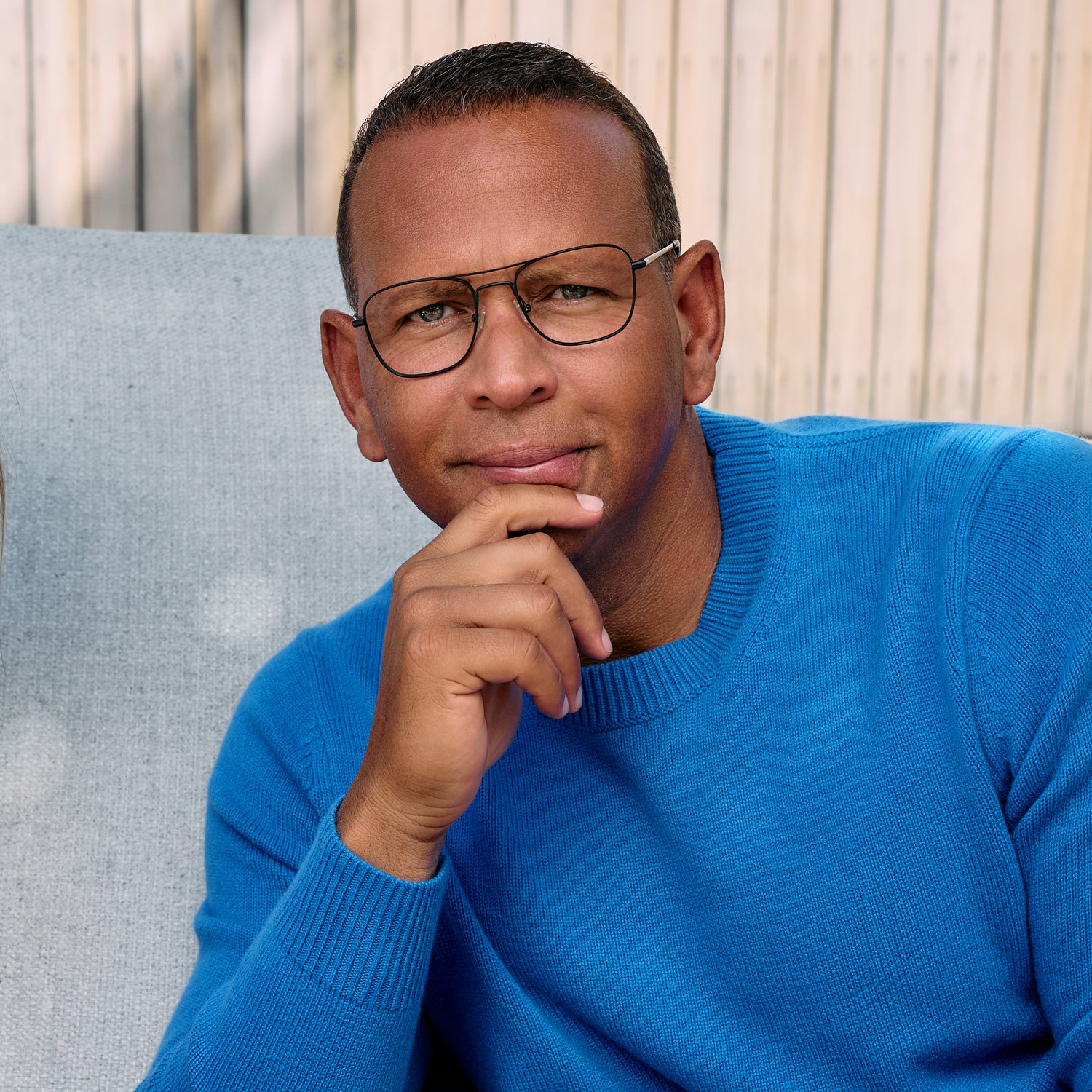 
A person in a white blazer wears matte black aviator-style eyeglasses with a double bridge and clear lenses.
