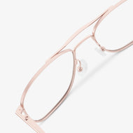 
Shiny rose gold aviator-style eyeglasses with a double bridge and clear lenses, shown in a close rear angled view highlighting the double bridge and adjustable nose pads.