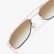 
Shiny rose gold aviator-style eyeglasses with a double bridge and brown gradient tinted lenses, shown in a close rear angled view highlighting the double bridge and adjustable nose pads.