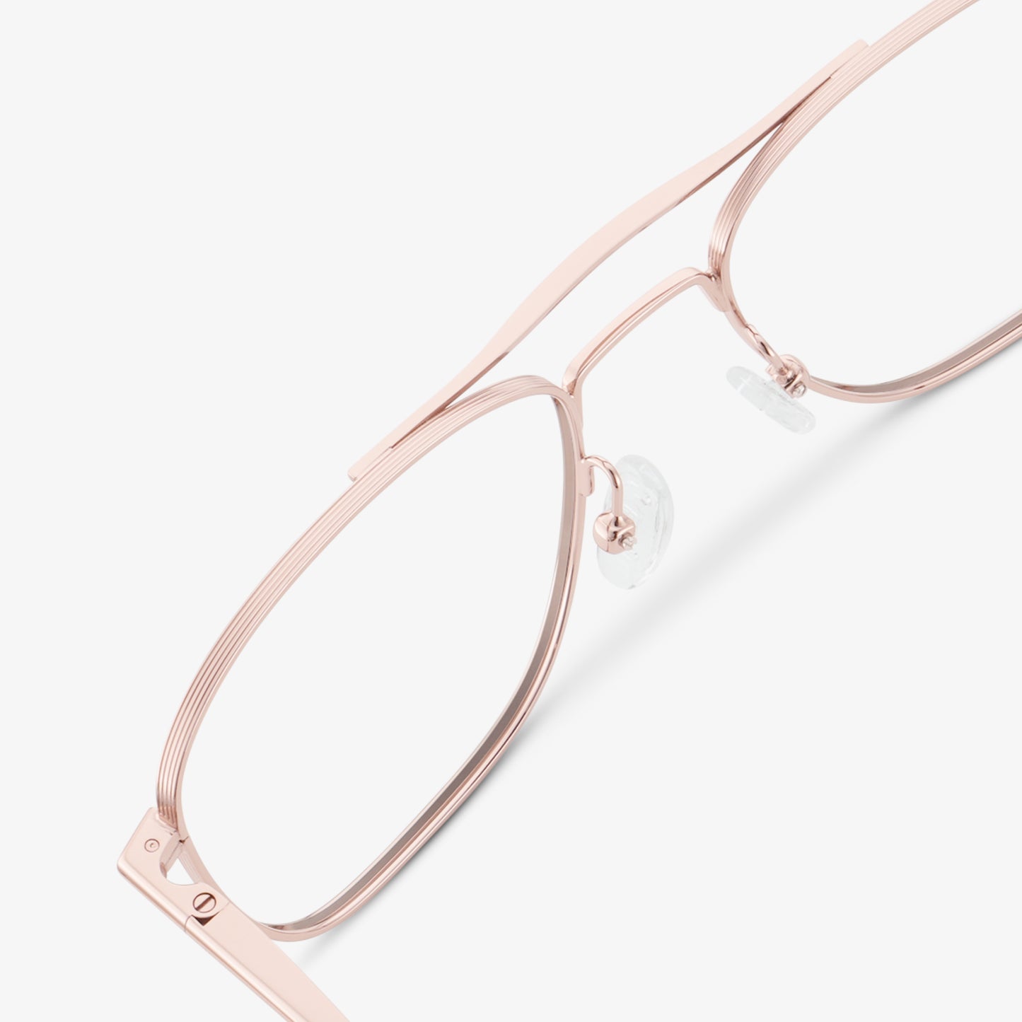 
Shiny rose gold aviator-style eyeglasses with a double bridge and clear lenses, shown in a close rear angled view highlighting the double bridge and adjustable nose pads.