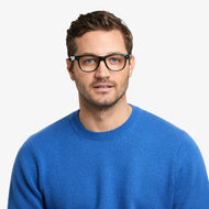 SU30PSFG10, SU30PSFG15, SU30PSFG20, SU30PSFG25, SU30PSFG30 - A person wears shiny dark green rectangular glasses with clear lenses.