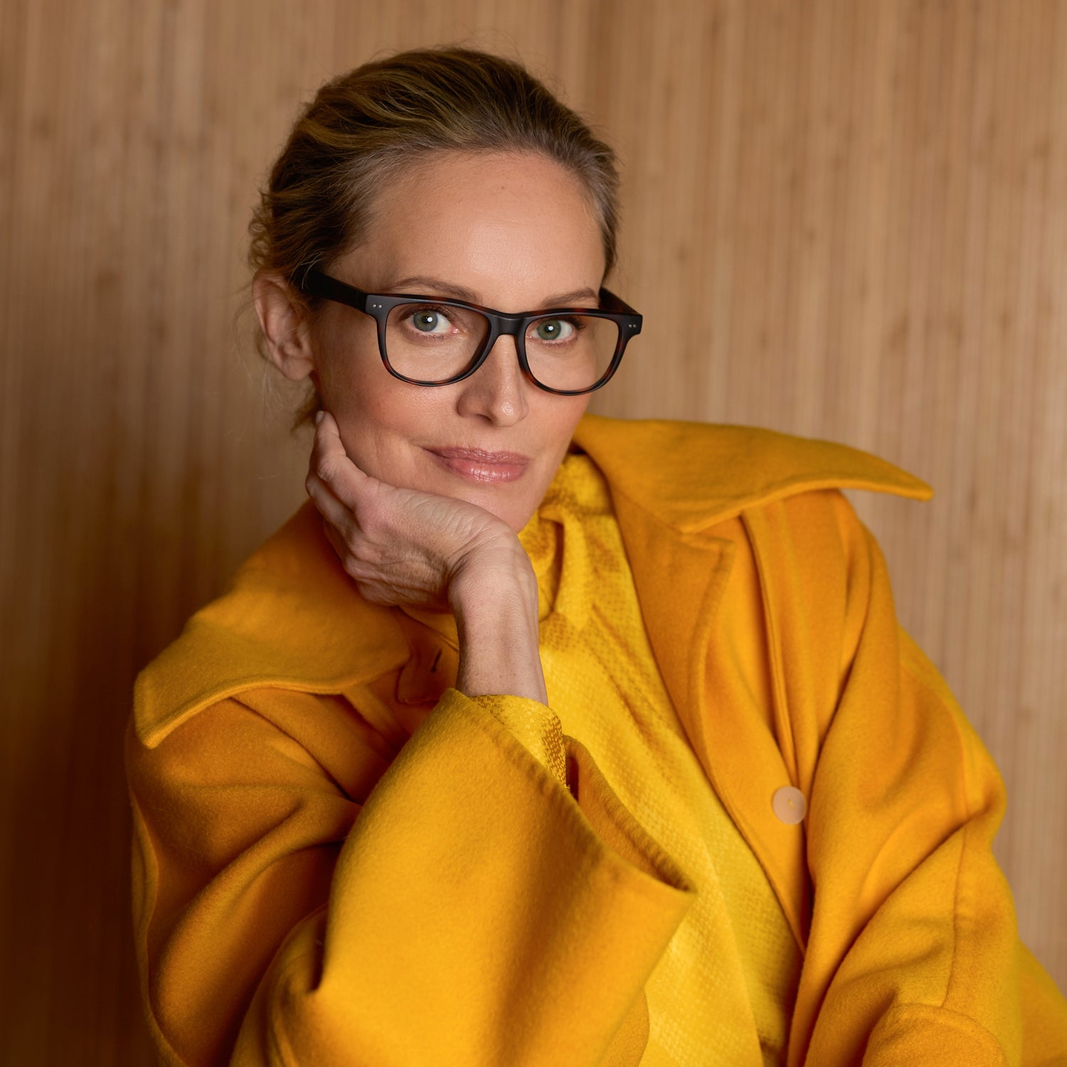 
A woman wears tortoise rectangular frames with clear lenses.