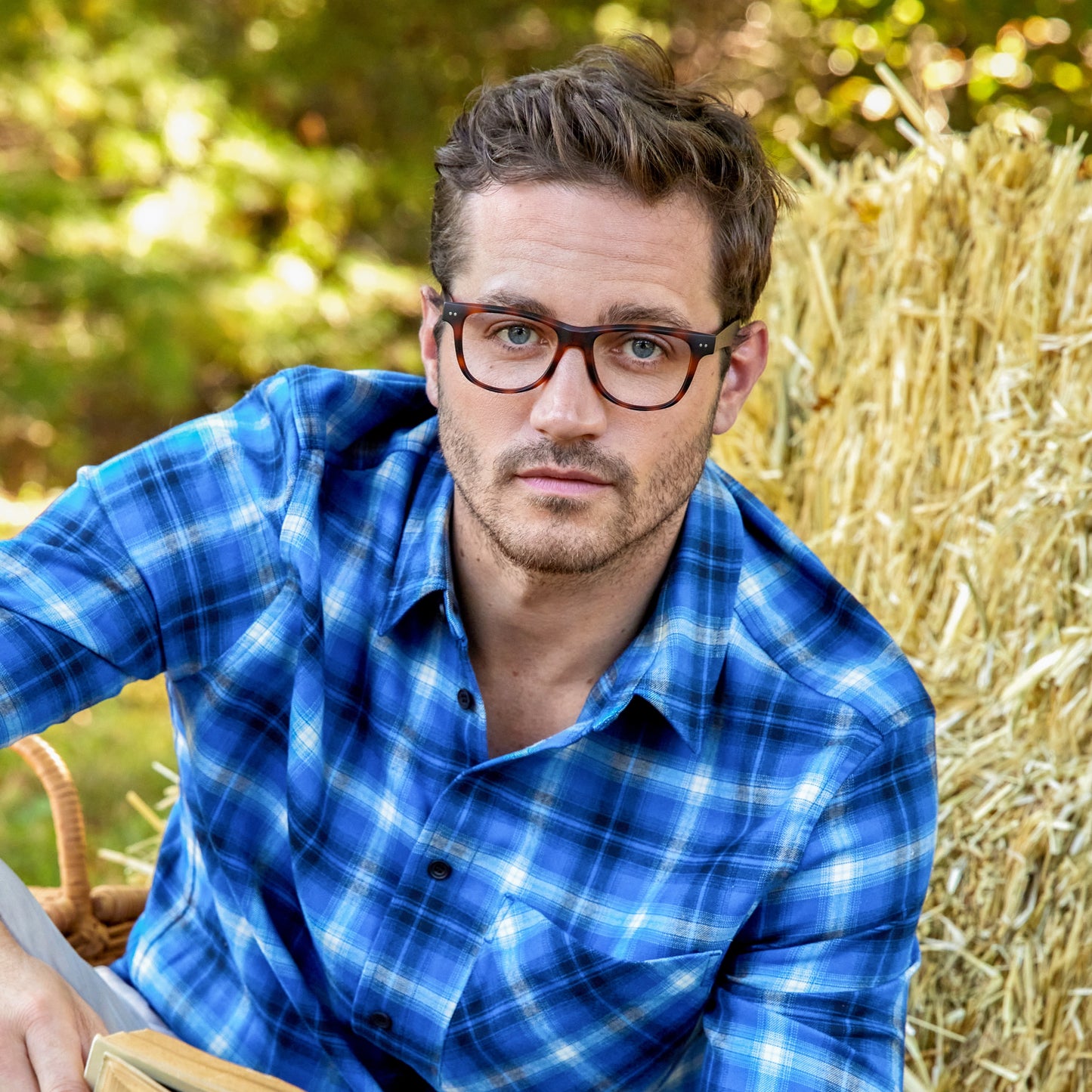 
A man wears tortoise rectangular frames with clear lenses.