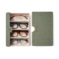 
Four pairs of eyeglasses with oval, rectangular, and rounded frames in rose gold, black, brown, and blue, all with clear lenses.