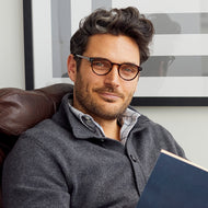 
Round tortoise glasses with clear lenses worn by a person.