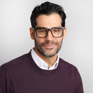 
Square tortoise frames with clear lenses worn by a person.