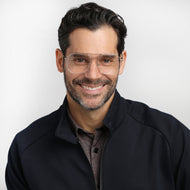 
Silver square frames with clear lenses are worn by a person.